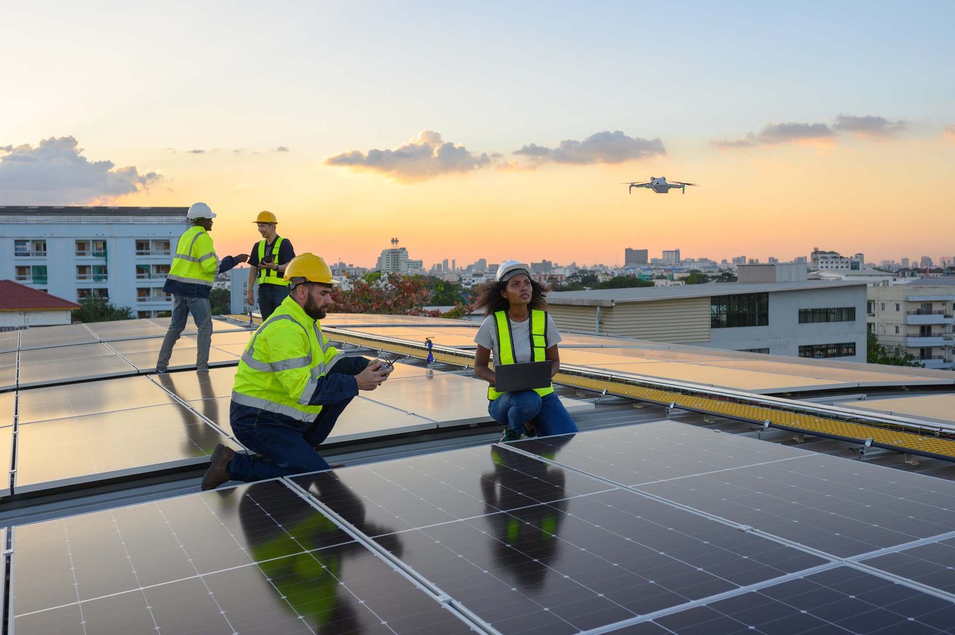 A team of engineers flies a drone to plan the installation of an outdoor solar panel system. Installing solar cells on the roof Solar panels on the roof Workers install eco-technology solar power plan